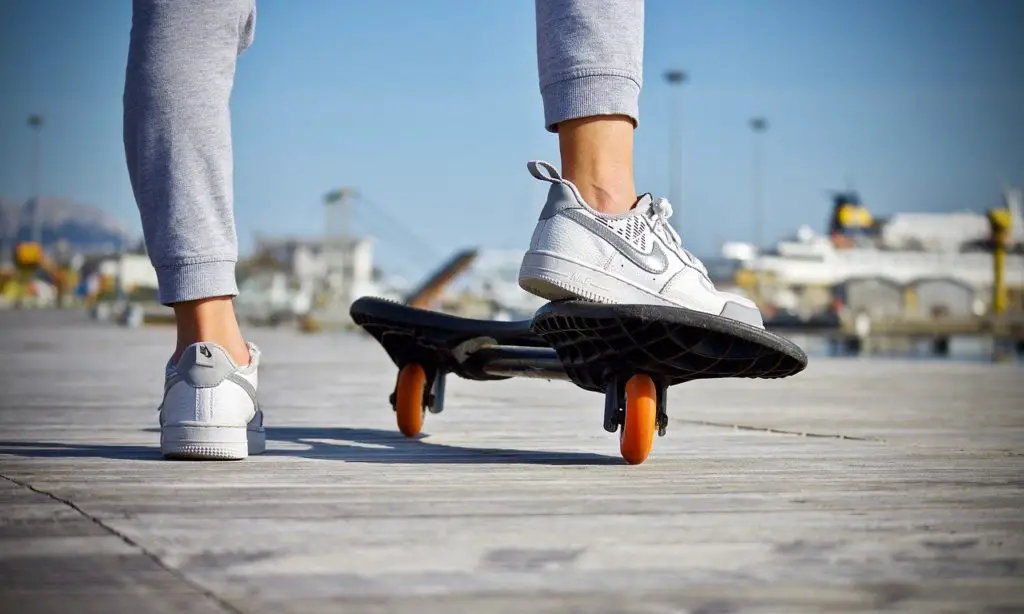 teen girl with feet on skateboard